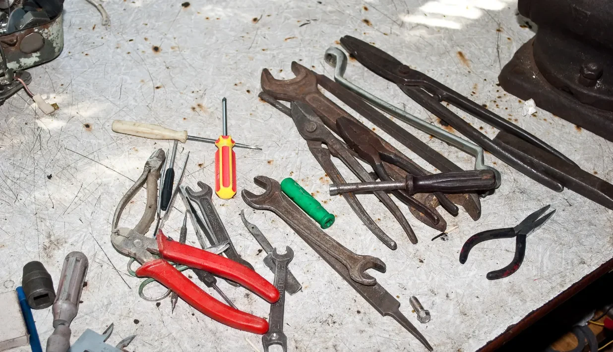 Assorted hand tools arranged on a workbench